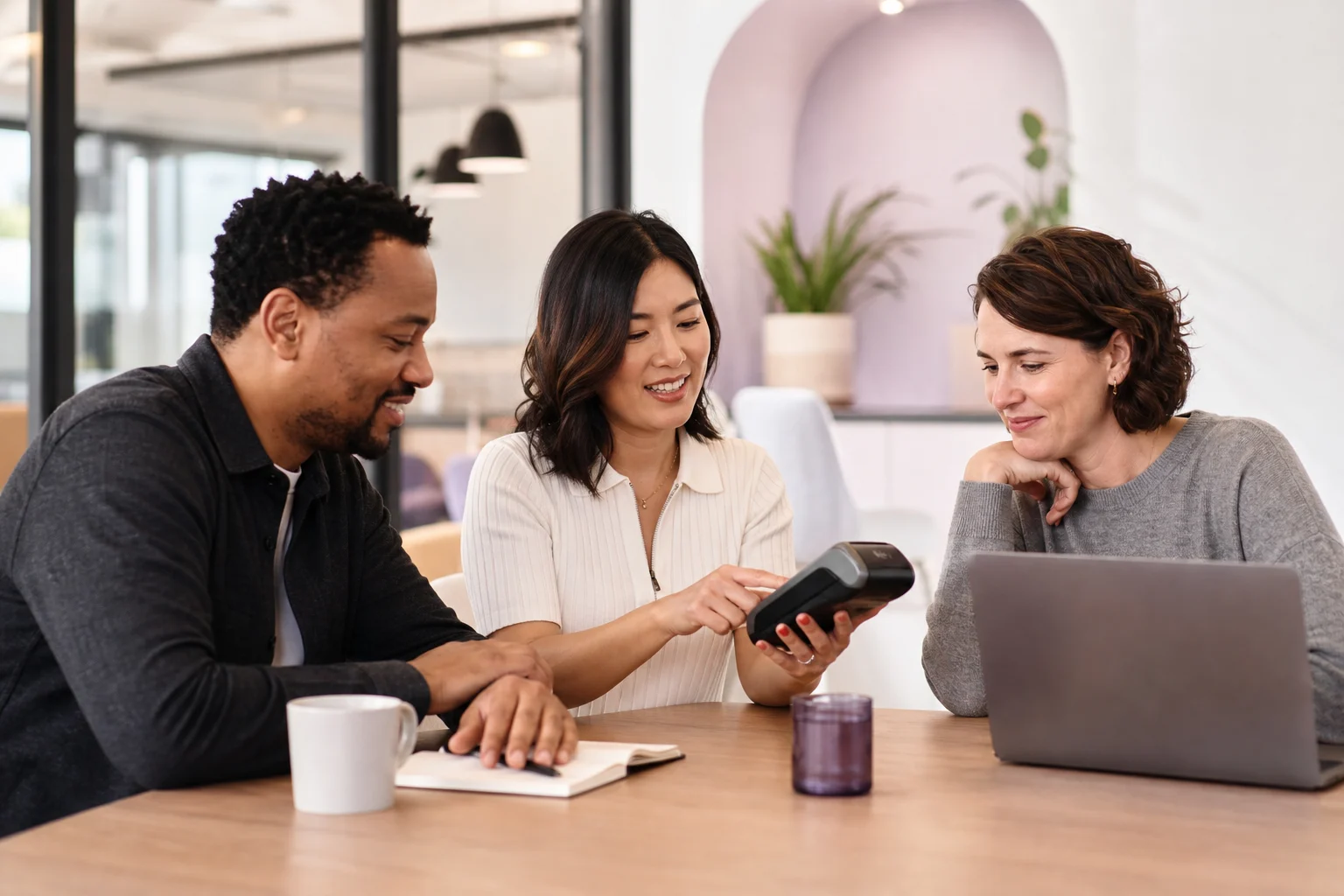 Sales and technology representatives collaborating on a merchant payment solution